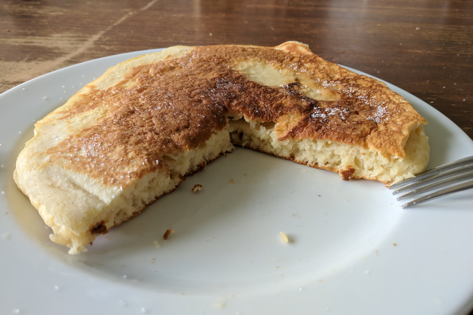 Image depicting a single pancake cut open to reveal the thick, fluffy centre